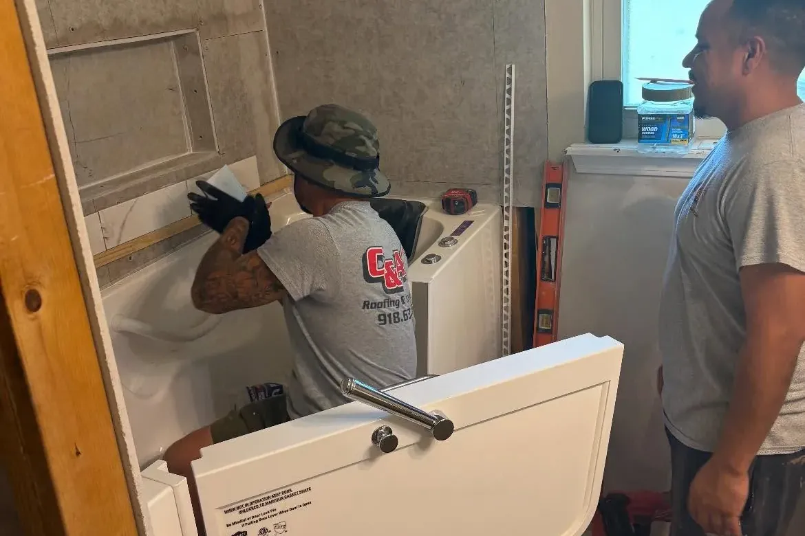 Crew installing walk-in tub during bathroom remodel, C&A Roofing & Construction