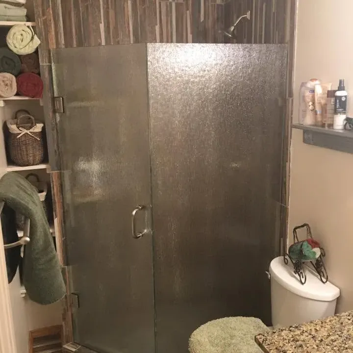 Corner glass shower with wood-look tile and vanity, C&A Roofing & Construction
