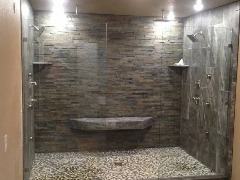 Large walk-in shower with stone tile and pebble floor, C&A Roofing & Construction
