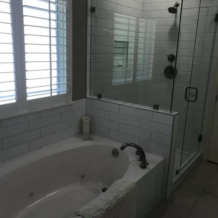 White subway tile tub surround, jetted tub, glass shower, C&A Roofing & Construction