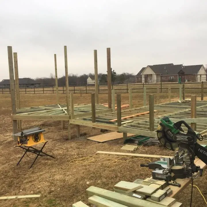New deck substructure framing with posts in open yard, C&A Roofing & Construction