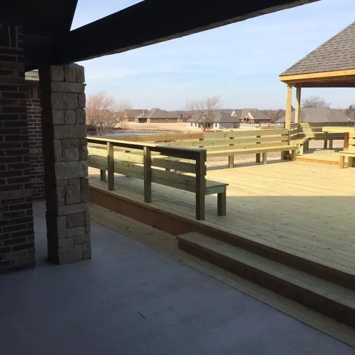 New deck with benches viewed from covered patio, C&A Roofing & Construction