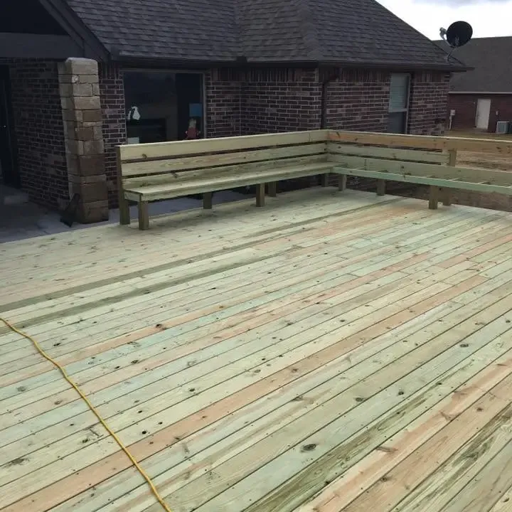New wood deck with built-in bench behind brick house, C&A Roofing & Construction