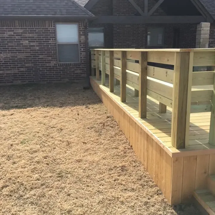 New deck railing and skirting along brick house, C&A Roofing & Construction