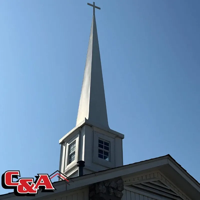 White church steeple against blue sky, C&A Roofing & Construction