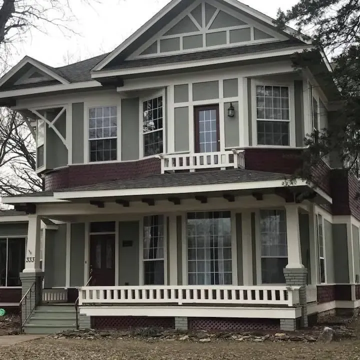 Repainted two-story Victorian house with porch, C&A Roofing & Construction