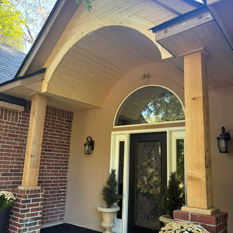 Front porch arch entry with wood soffit and columns, C&A Roofing & Construction