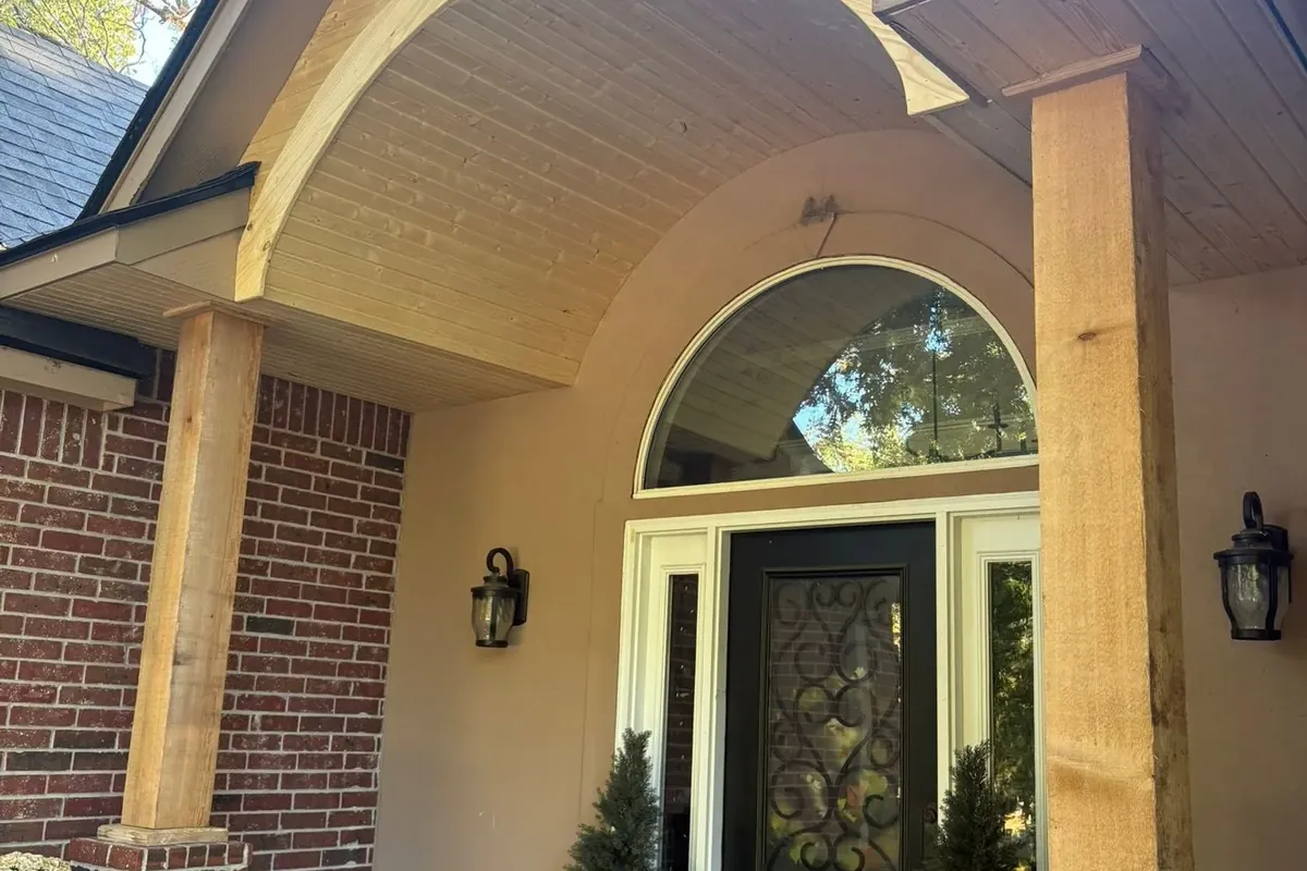 Front porch arch entry with wood soffit and columns, C&A Roofing & Construction