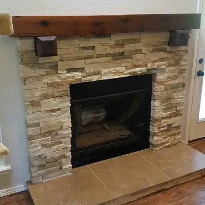 Stone veneer fireplace with wood mantel and tile hearth, C&A Roofing & Construction