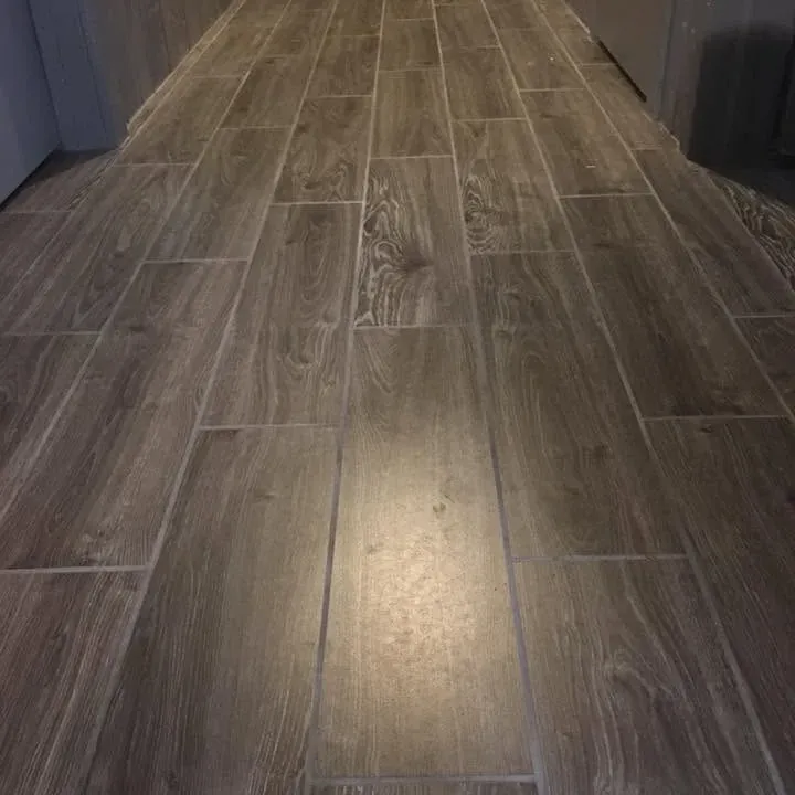 Wood-look tile in hallway lit by overhead light, C&A Roofing & Construction