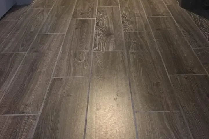 Wood-look tile in hallway lit by overhead light, C&A Roofing & Construction