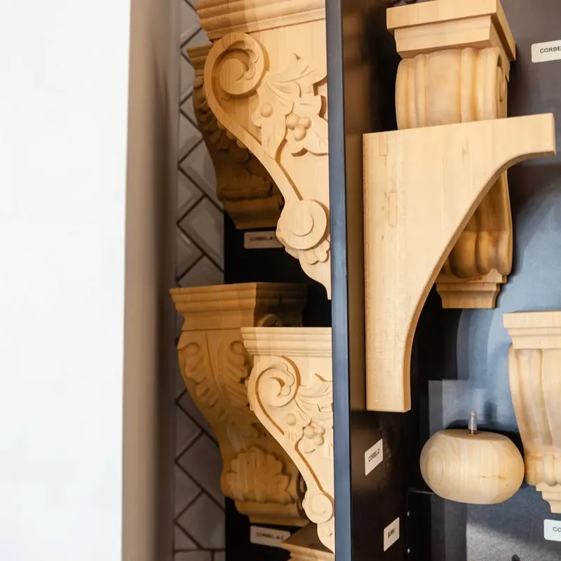 Showroom display of carved wooden corbels, C&A Roofing & Construction