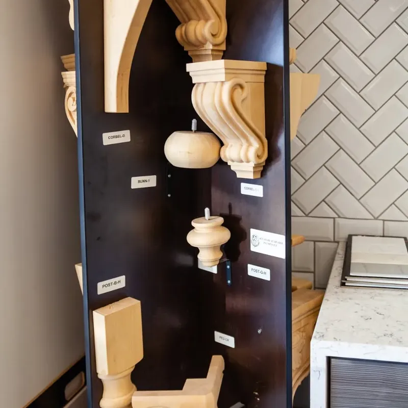 Wood corbels, posts and trim samples on display wall, C&A Roofing & Construction