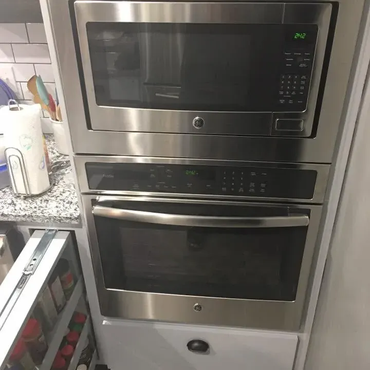 Stainless built-in wall oven and microwave in gray cabinetry, C&A Roofing & Construction