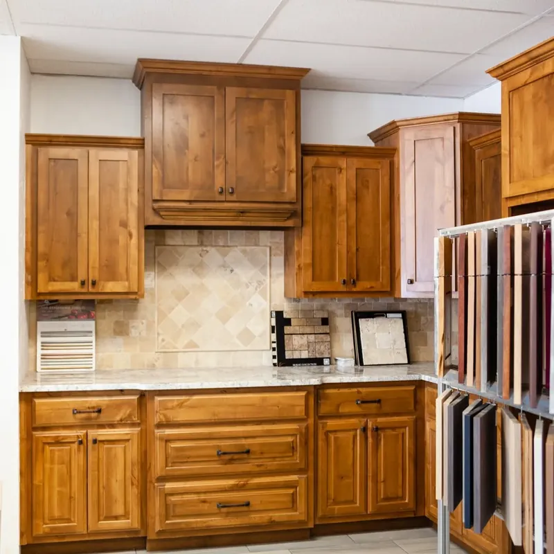 Showroom kitchen display with wood cabinets and tile backsplash, C&A Roofing & Construction