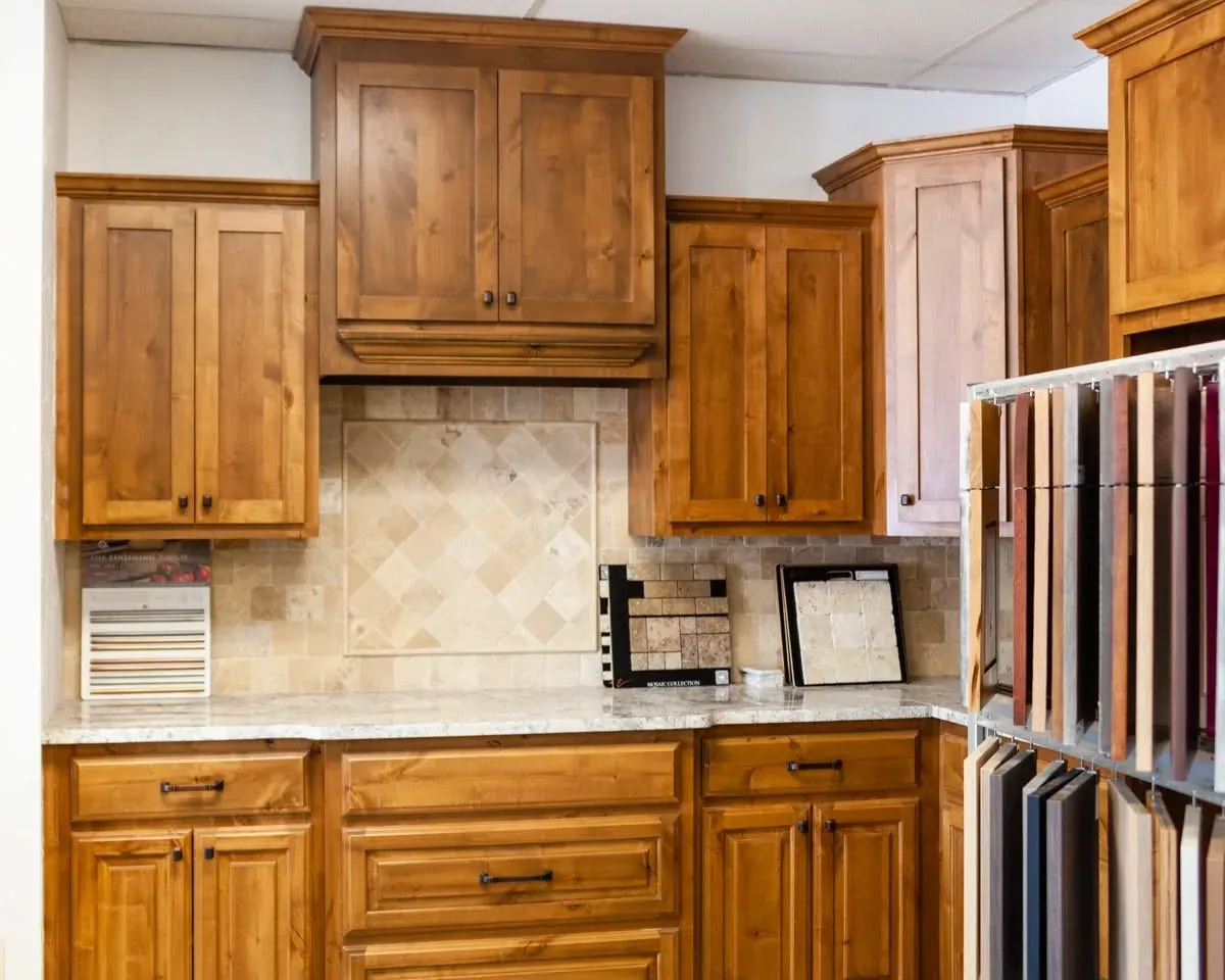 Showroom kitchen display with wood cabinets and tile backsplash, C&A Roofing & Construction