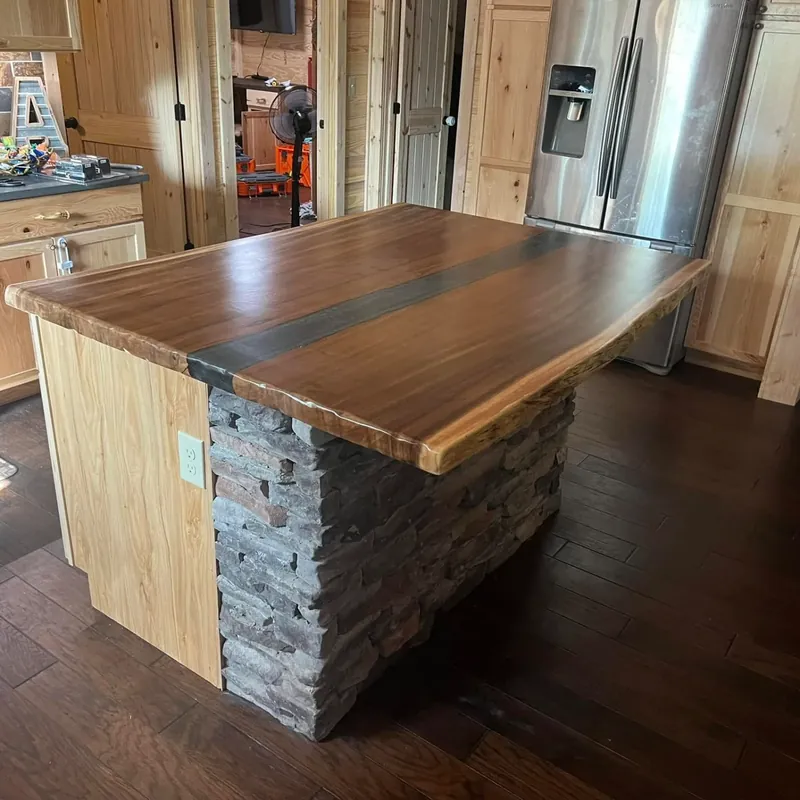 Custom island with live-edge wood top and stone base, C&A Roofing & Construction