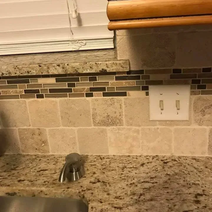 Granite countertop with tile mosaic backsplash close-up, C&A Roofing & Construction