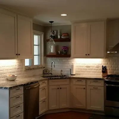 Finished white-cabinet kitchen with subway tile and range hood, C&A Roofing & Construction