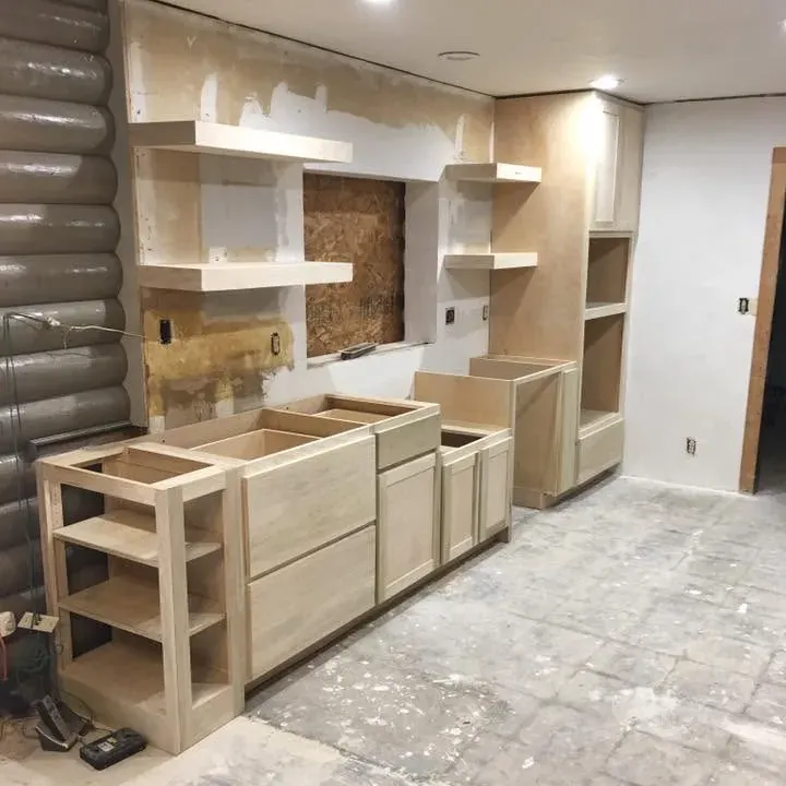 Unfinished cabinets and open shelving on bare slab, C&A Roofing & Construction