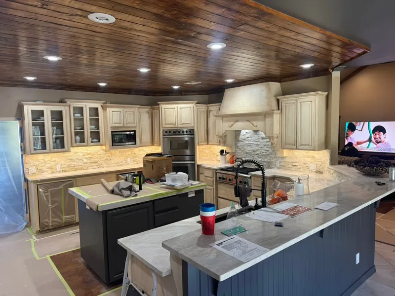 Kitchen with new cabinets, island and wood plank ceiling, C&A Roofing & Construction