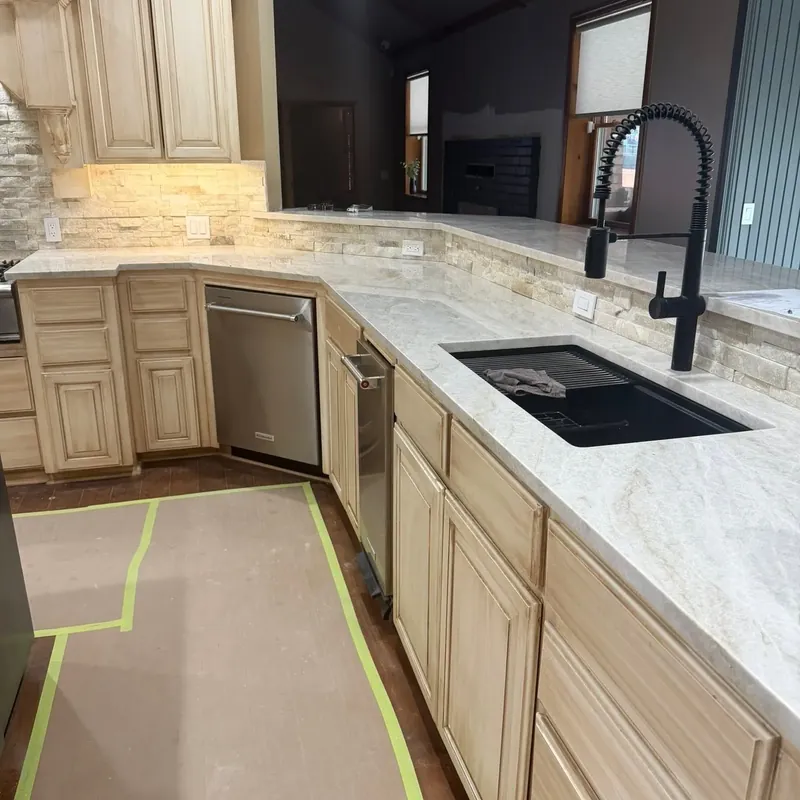 Cream cabinets with black sink, faucet and new backsplash, C&A Roofing & Construction
