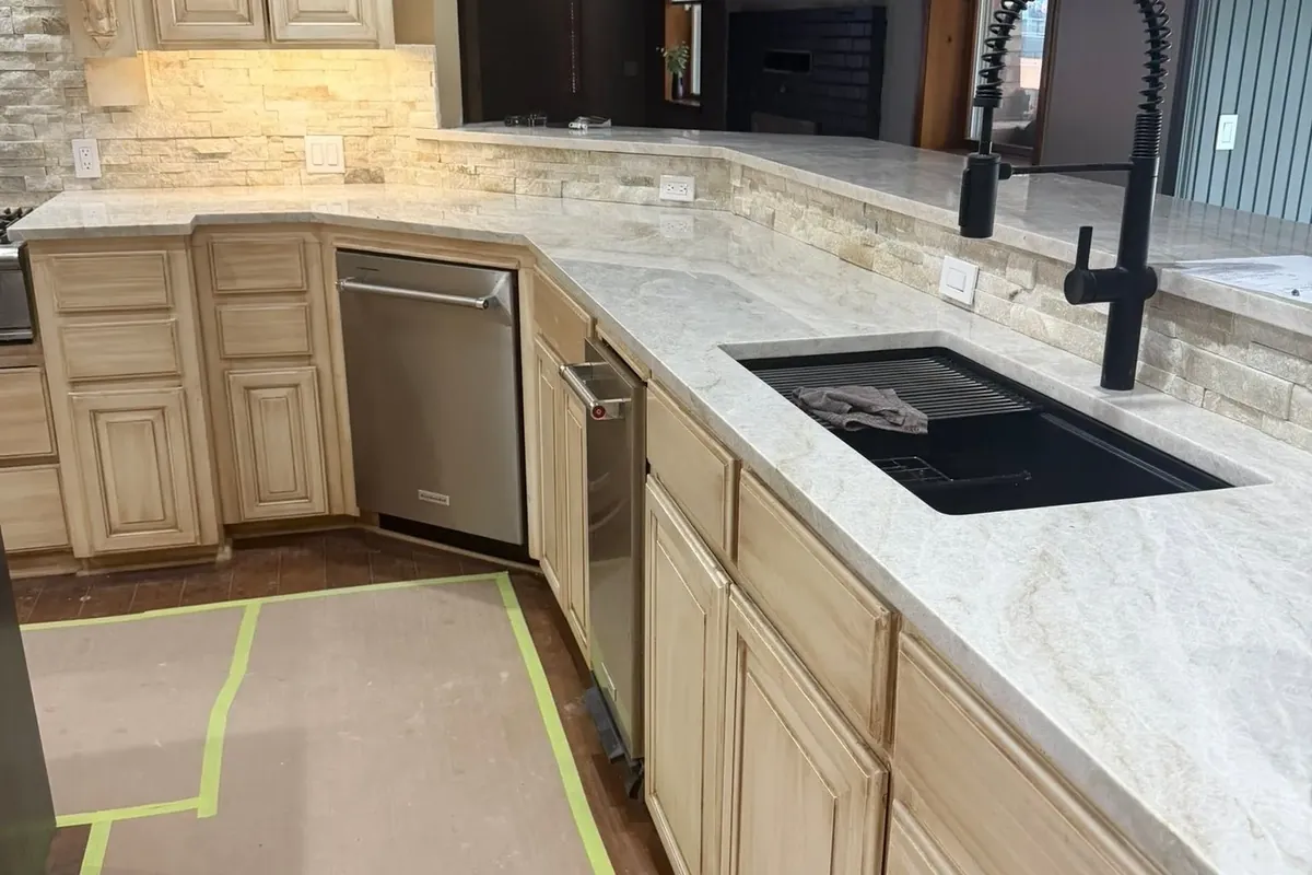 Cream cabinets with black sink, faucet and new backsplash, C&A Roofing & Construction