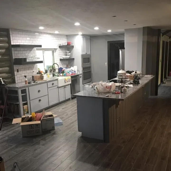 Kitchen with new wood-look tile floor and island, C&A Roofing & Construction