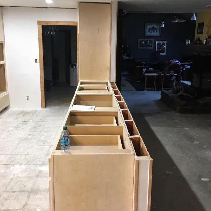Row of unfinished base cabinet boxes being installed, C&A Roofing & Construction