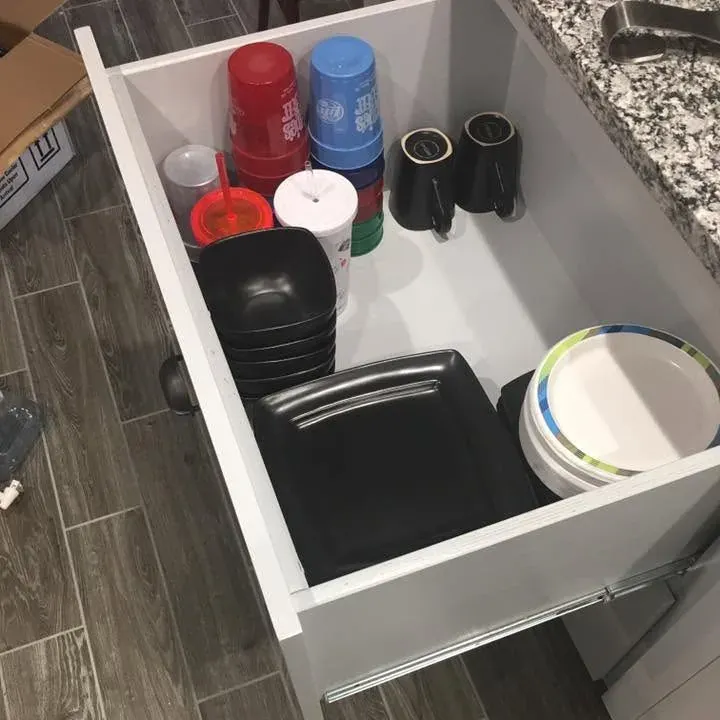 Open white drawer with dishes over wood-look tile, C&A Roofing & Construction
