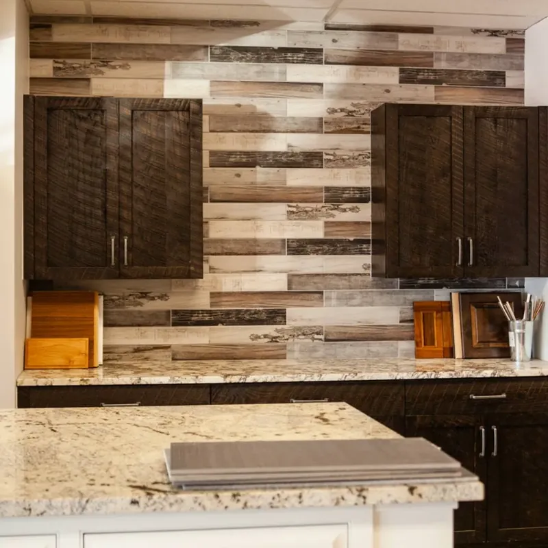 Dark rustic cabinets on multi-tone wood plank wall, granite counters, C&A Roofing & Construction
