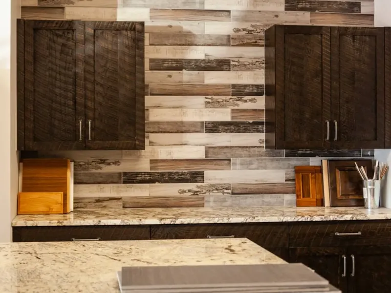 Dark rustic cabinets on multi-tone wood plank wall, granite counters, C&A Roofing & Construction