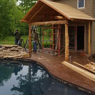 Wooden pool house with porch beside swimming pool, C&A Roofing & Construction