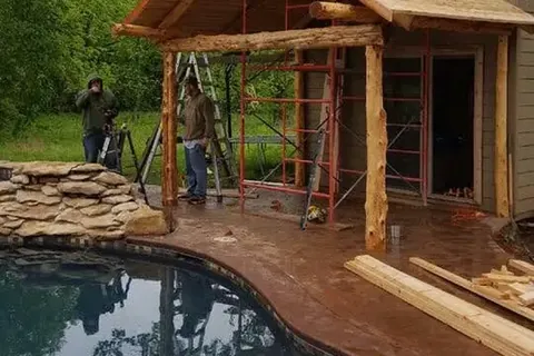 Wooden pool house with porch beside swimming pool, C&A Roofing & Construction