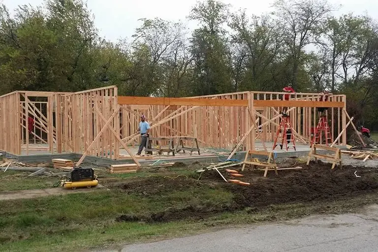 Crew framing single-story house walls on new slab, C&A Roofing & Construction