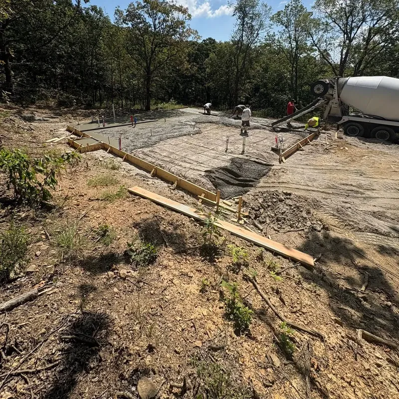 Concrete pour in foundation forms with mixer truck behind, C&A Roofing & Construction