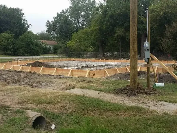 Foundation forms laid out on lot next to utility pole, C&A Roofing & Construction