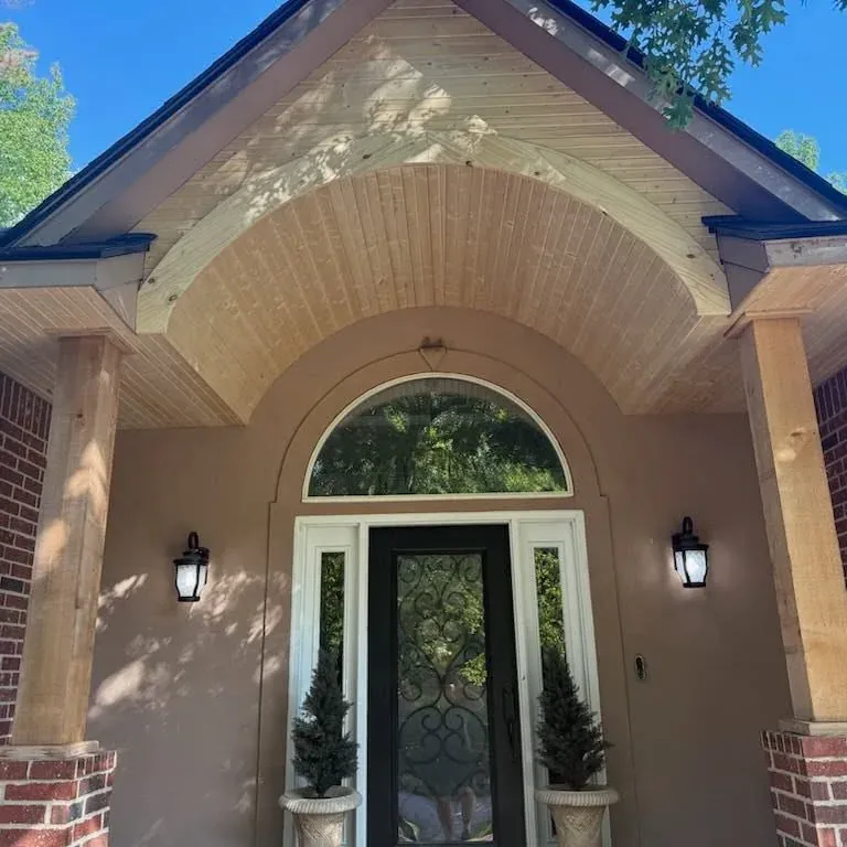 Finished arched front porch entry with wood soffit and columns, C&A Roofing & Construction
