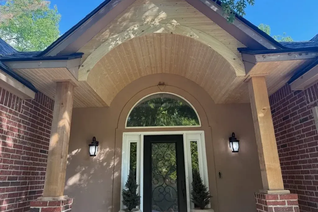 Finished arched front porch entry with wood soffit and columns, C&A Roofing & Construction