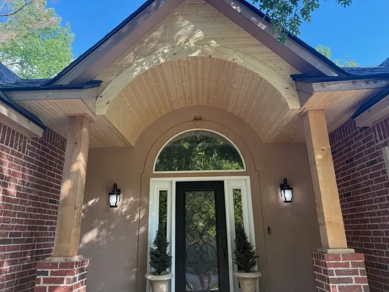 Finished arched front porch entry with wood soffit and columns, C&A Roofing & Construction