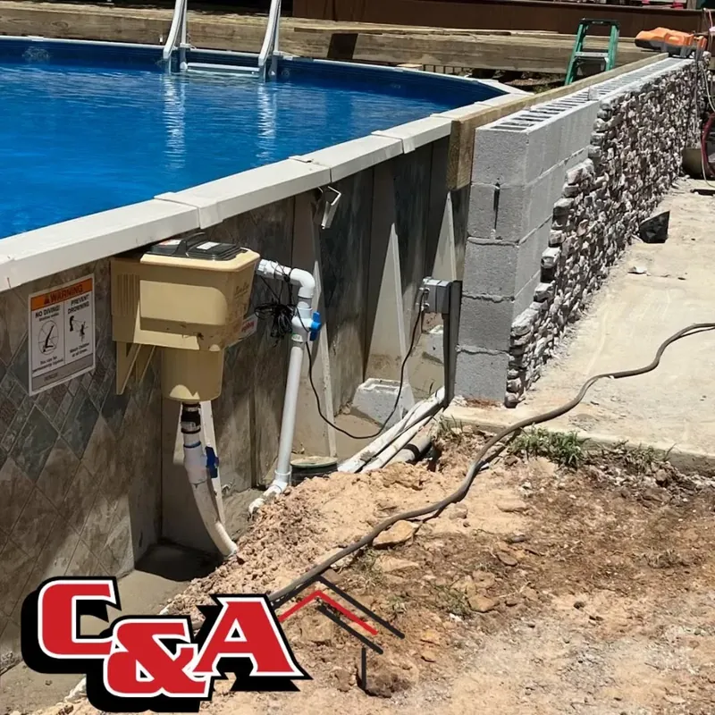 Above-ground pool with concrete block wall and pump, C&A Roofing & Construction