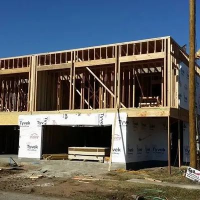 Two-story wood framing on raised foundation with crane, C&A Roofing & Construction