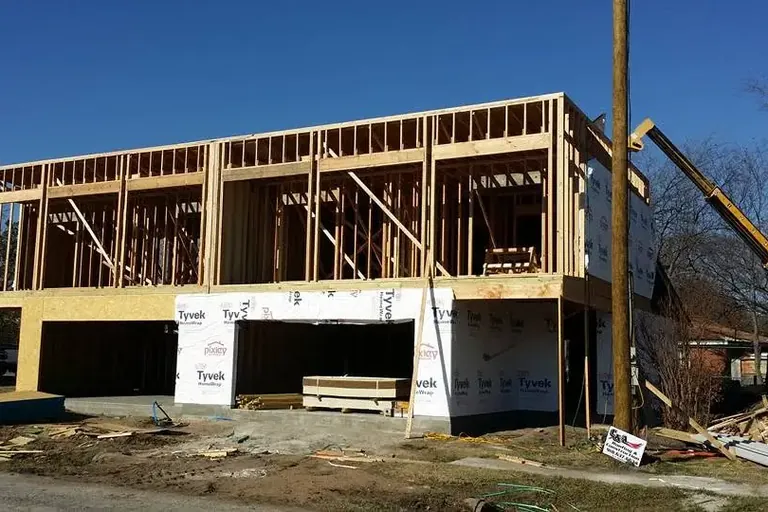 Two-story wood framing on raised foundation with crane, C&A Roofing & Construction