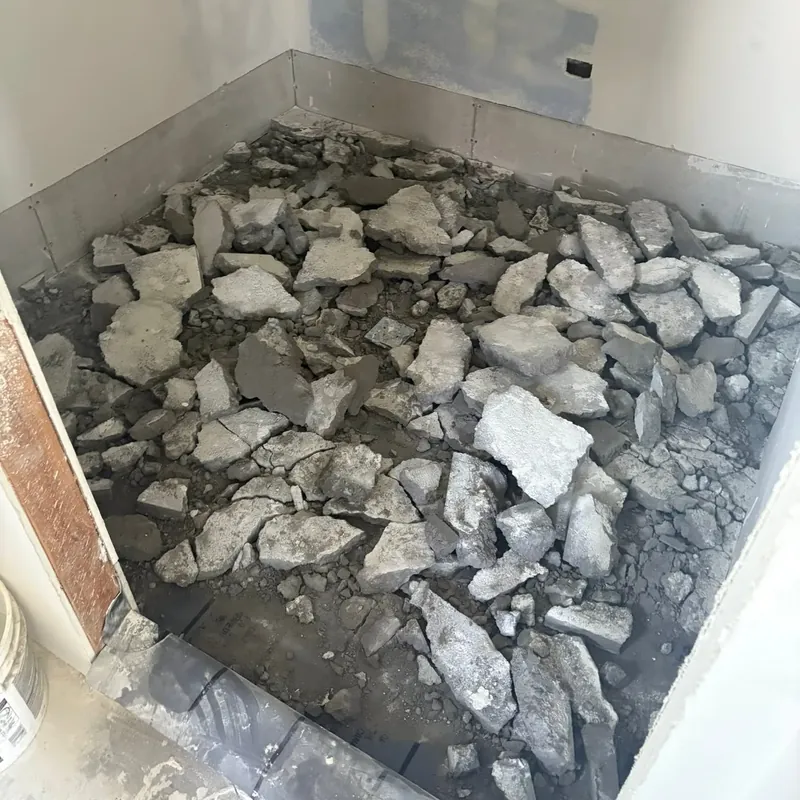 Bathroom shower pan torn out, pile of tile debris, C&A Roofing & Construction
