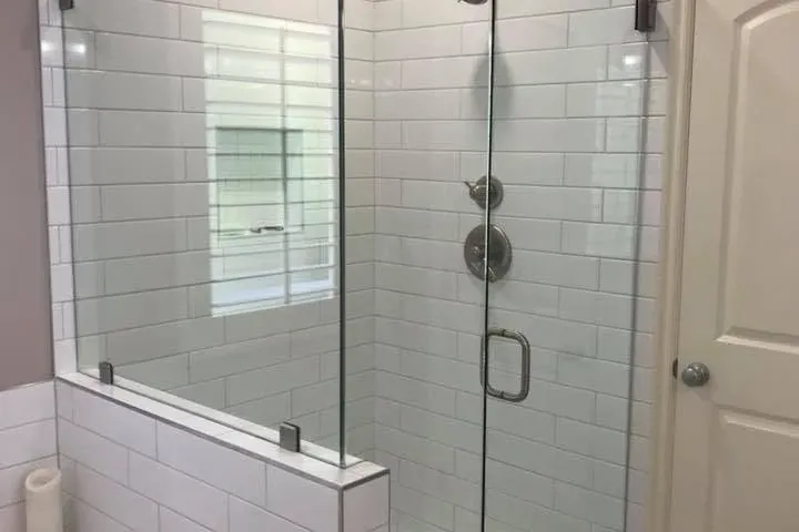 Finished white subway tile shower with glass enclosure and tub, C&A Roofing & Construction