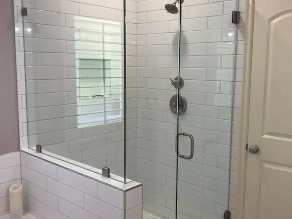 Finished white subway tile shower with glass enclosure and tub, C&A Roofing & Construction