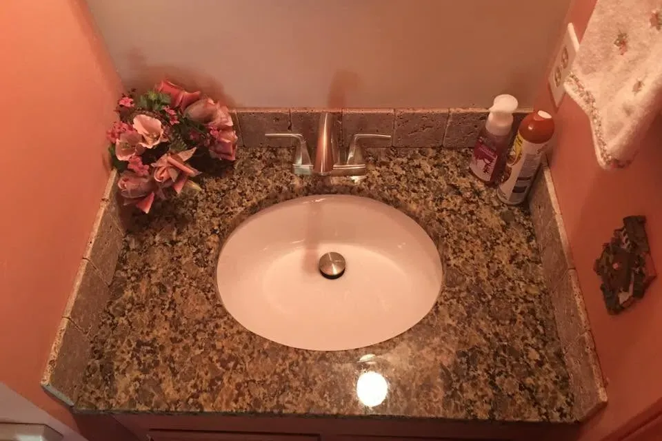 Granite vanity top with undermount sink and faucet, C&A Roofing & Construction
