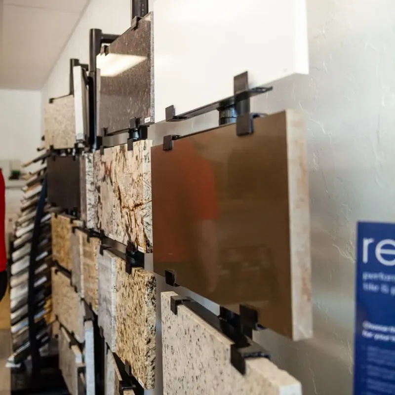 Countertop slab samples hanging on showroom rack, C&A Roofing & Construction