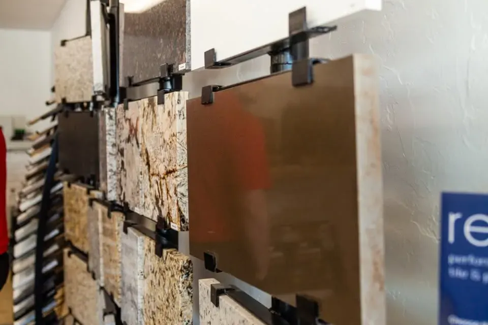 Countertop slab samples hanging on showroom rack, C&A Roofing & Construction