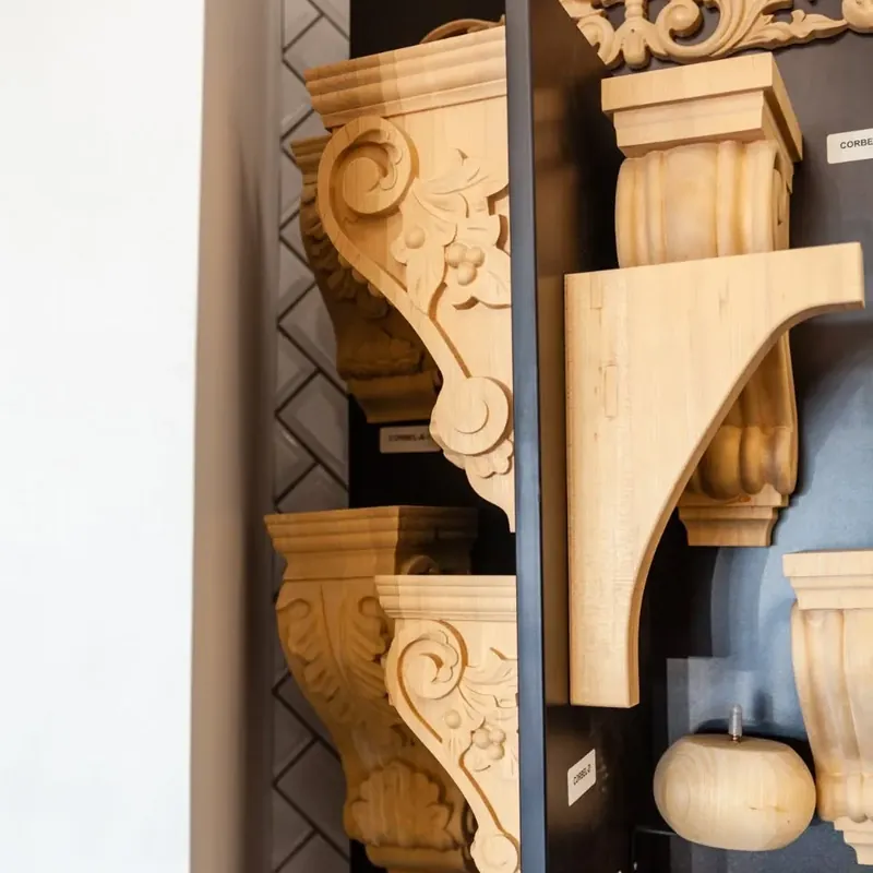Carved wooden corbels on showroom display wall, C&A Roofing & Construction